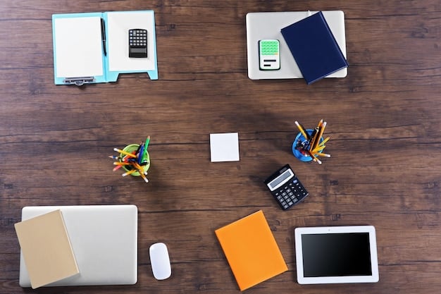 A top-down view of a meticulously organized workspace, featuring a laptop displaying a grant proposal document, surrounded by notes, diagrams, and League of Legends-themed merchandise, symbolizing preparation and dedication to a grant application.