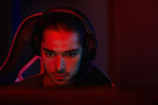 A close-up of a professional esports player intensely focused on the game, highlighting the skill and dedication required for competitive gaming.