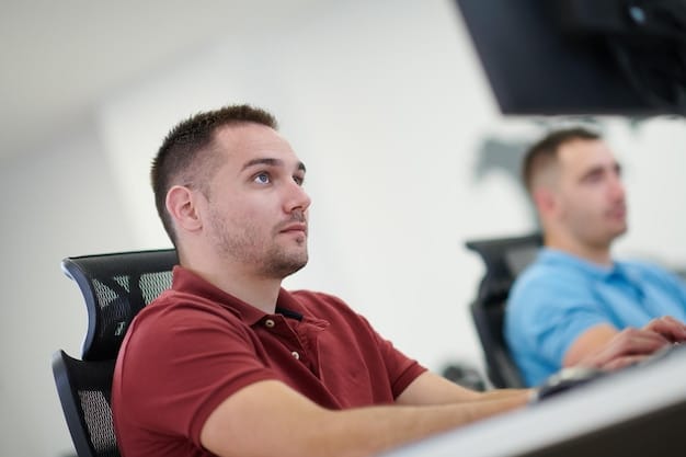 A close-up shot of a coach mentoring a student during an esports training session. The coach is pointing to a screen displaying gameplay footage, providing detailed feedback and strategic insights. The student is attentive and focused, demonstrating a willingness to learn.