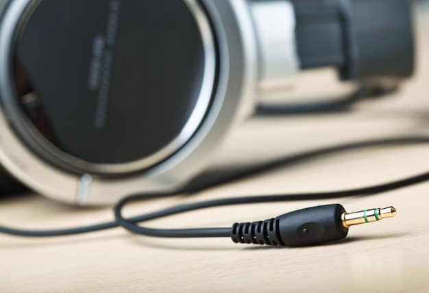 A close-up shot of a headphone jack connected to a sophisticated audio interface, highlighting the importance of proper connection for optimal audio quality.