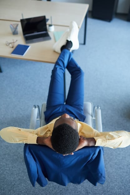An overhead shot of a person's hands comfortably positioned on a Kinesis Advantage360 ergonomic split keyboard, highlighting the natural wrist alignment and tented design, with a blurred office background.