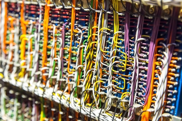 A close-up shot of a 24-pin ATX custom sleeved cable neatly routed, showing different color combinations and the use of cable combs for uniform spacing.
