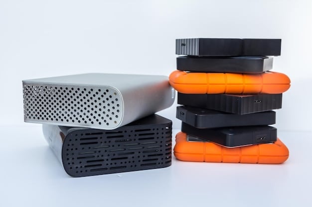 A stack of various external hard drives, ranging from sleek SSDs to bulkier HDDs, clearly showing their different physical forms and sizes, illustrating storage options.