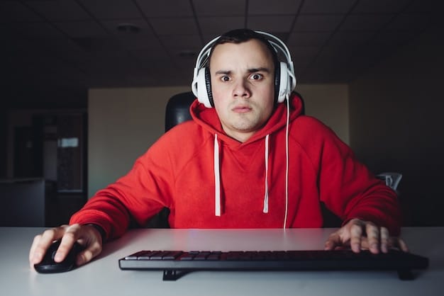 A student focused on a screen, participating in an online lecture or study session, with gaming peripherals subtly visible in the background, symbolizing the blend of academics and esports.