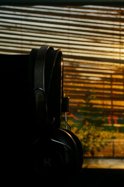 A close-up of a gaming headset and microphone in front of a blurred screen showing esports gameplay, symbolizing communication and audio in competitive gaming.