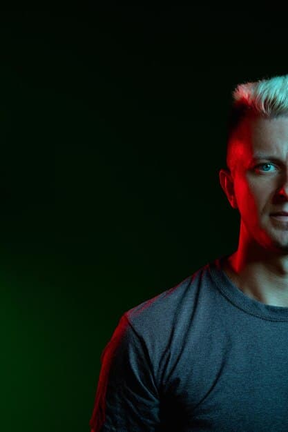 A close-up shot of an esports player, bathed in dramatic lighting, with a graphic overlay displaying their key stats and a brief bio, embodying the personalized storytelling focus in modern broadcasts.