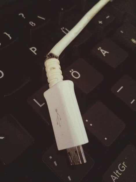 A close-up of a USB-C connector being plugged into a laptop. The focus is on the USB-C port and connector, highlighting 'USB Microphones: 5 Features to Consider for Clearer Voice Chat' and the ease of connectivity. The laptop is on a clean desk, with a blurred background showing a minimalist workspace